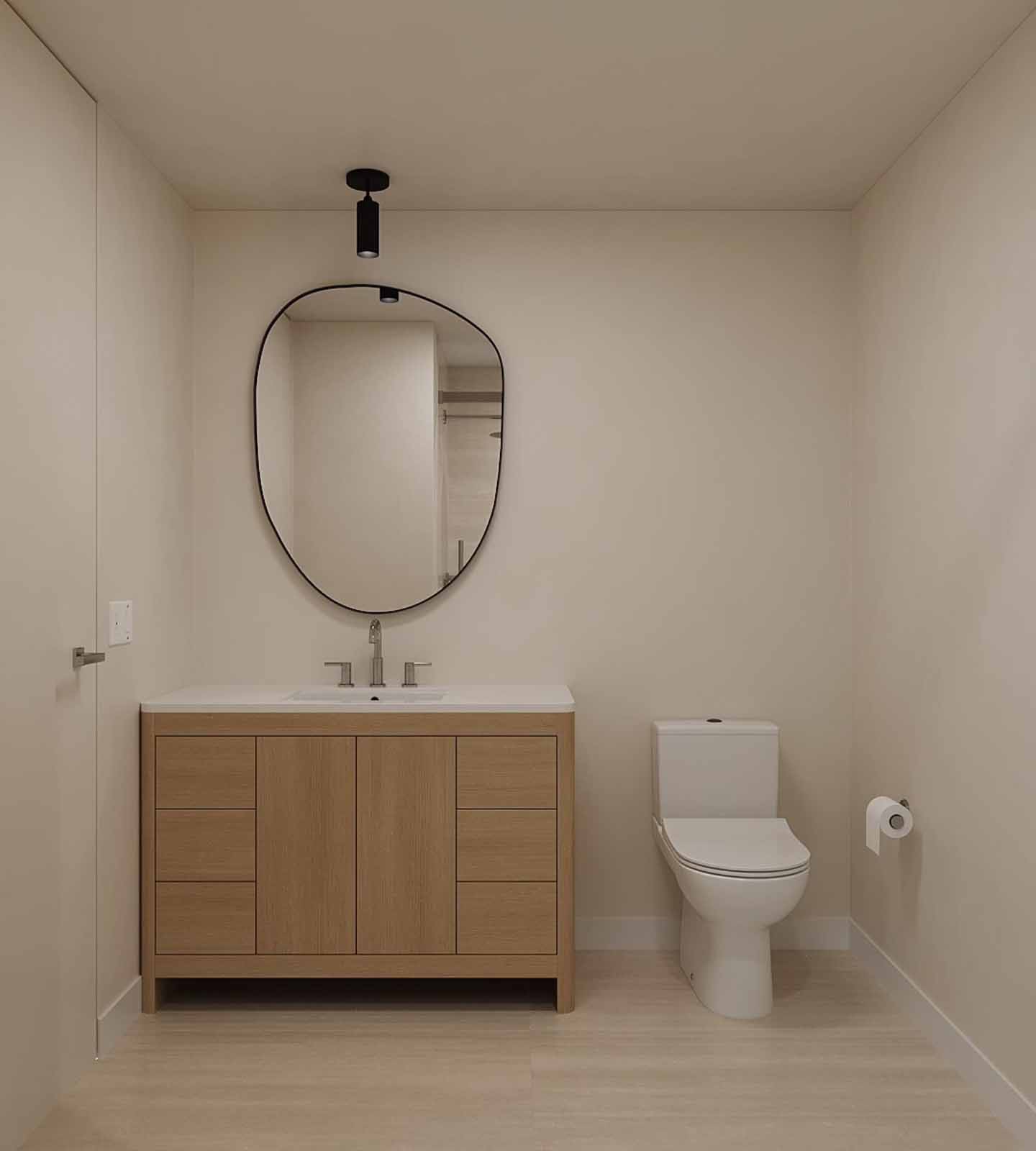 Minimalist powder room with oak vanity, organic-shaped mirror, and pendant light