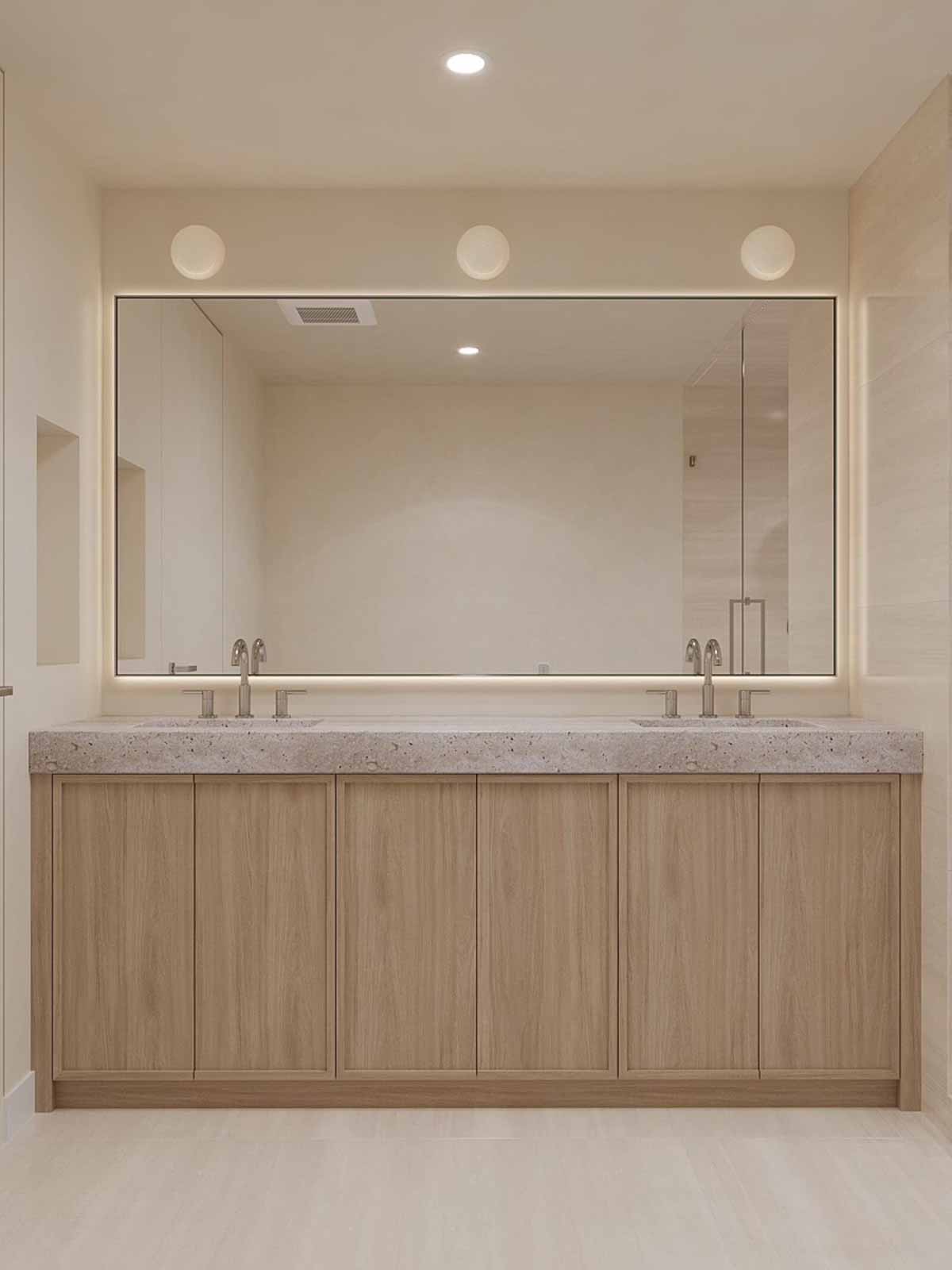 Spa-inspired double vanity with terrazzo countertop, backlit mirror, and globe sconces