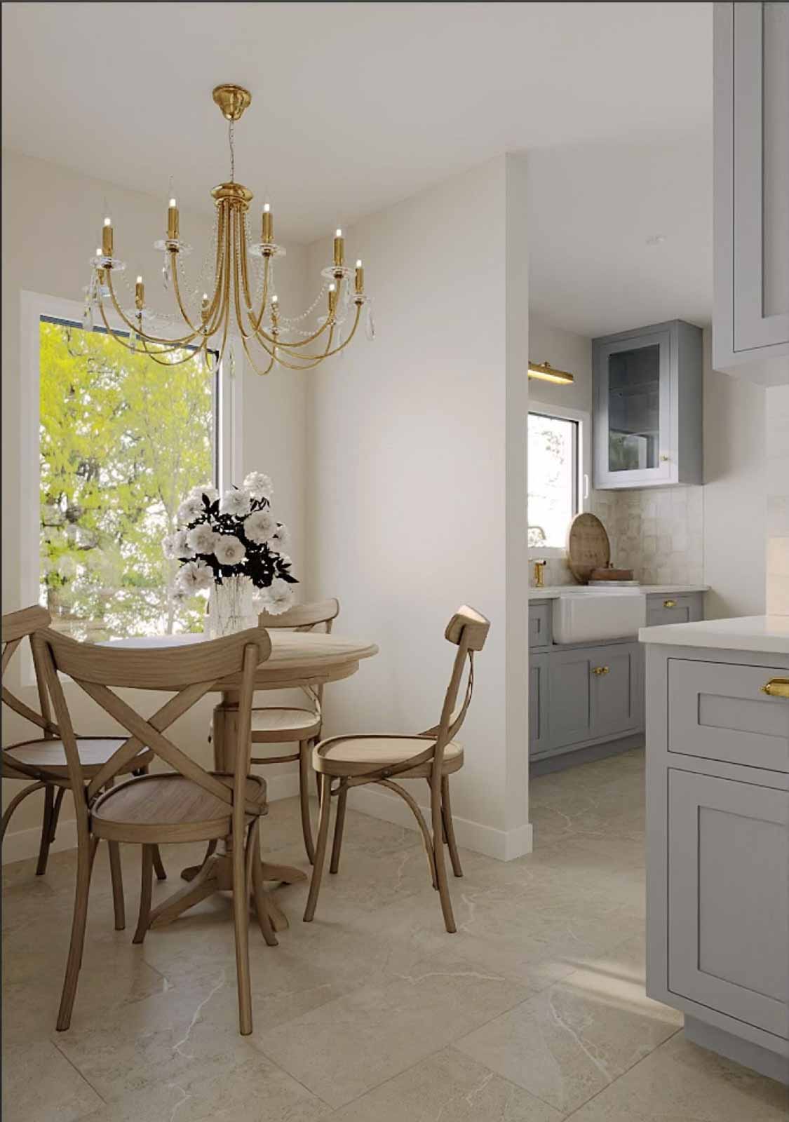 Cottage dining nook with oak bistro table, cross-back chairs, gold chandelier, and garden view