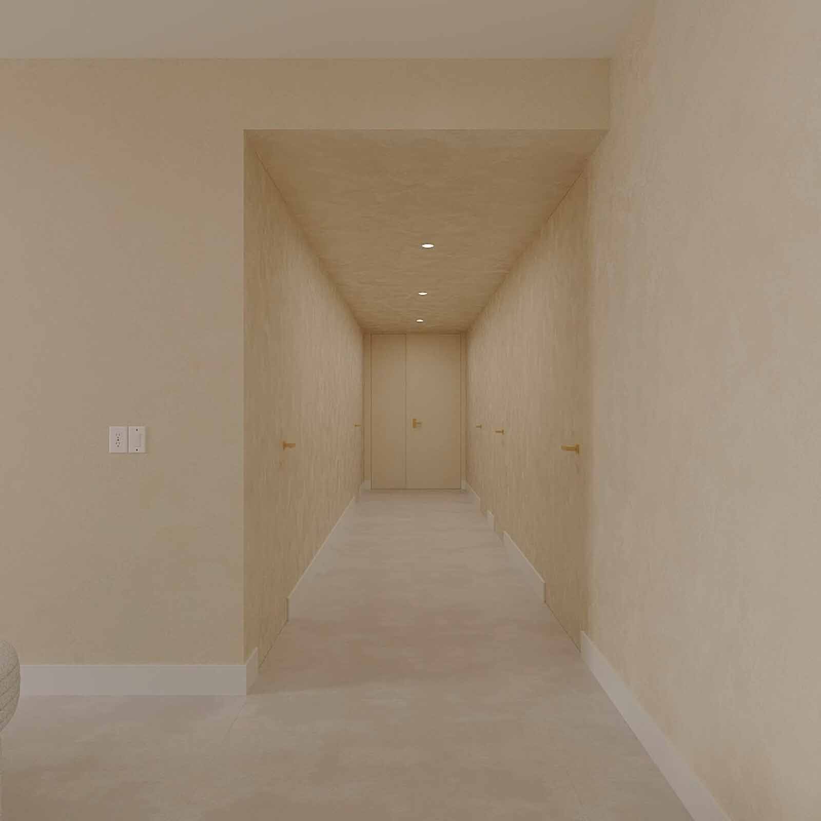 Warm minimalist hallway with textured walls, recessed lighting, and brass door handles