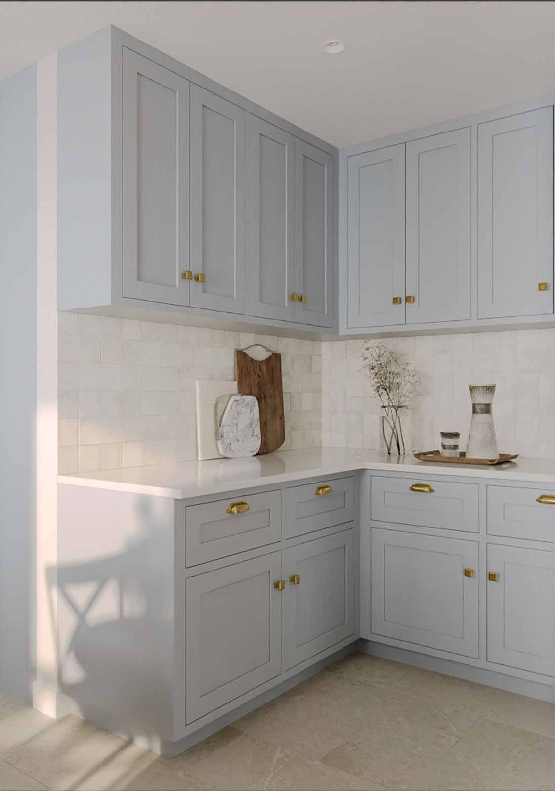 Corner kitchen with dove gray cabinets, zellige tile backsplash, brass hardware, and natural light
