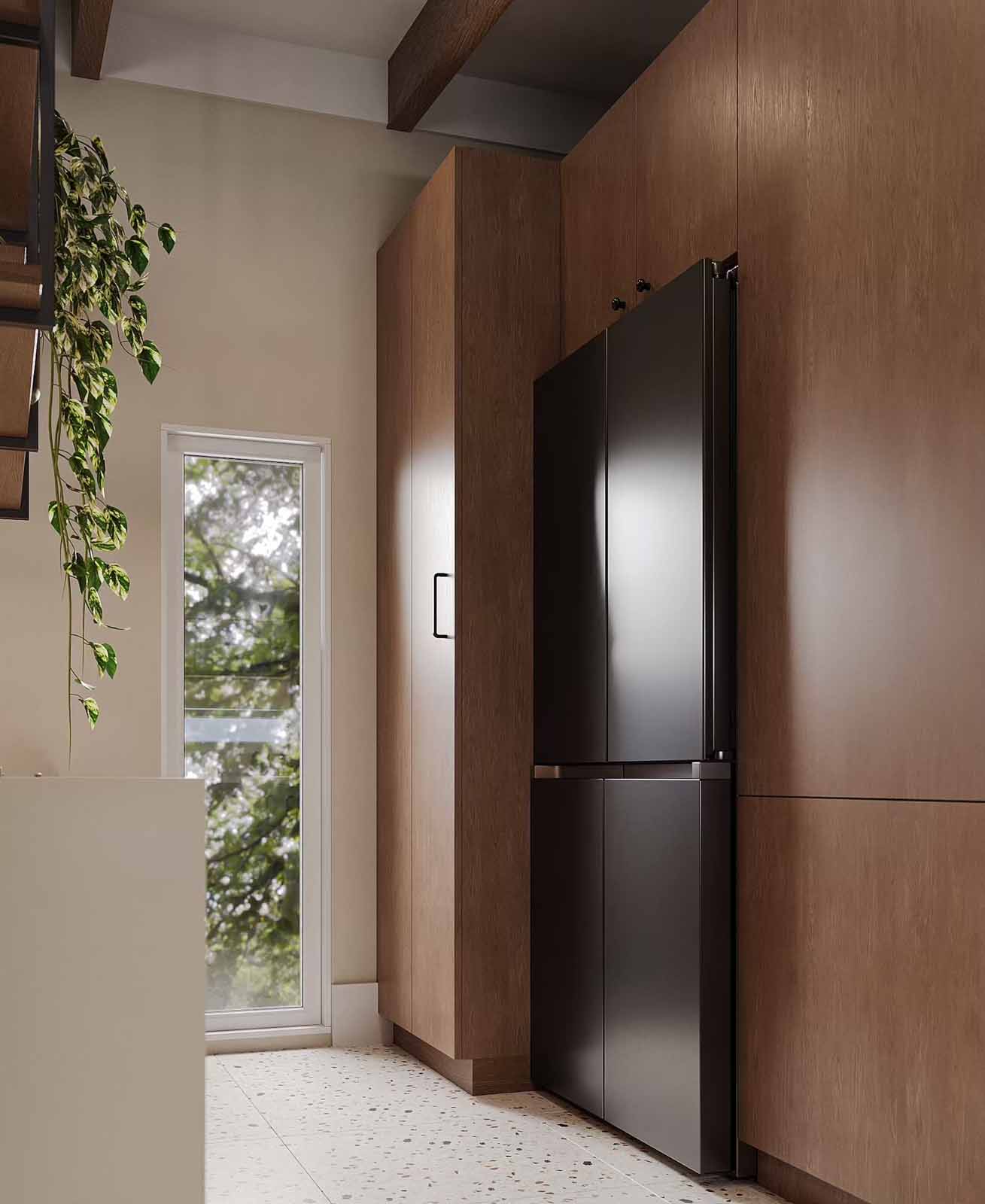 Floor-to-ceiling walnut cabinetry with integrated refrigerator and terrazzo flooring