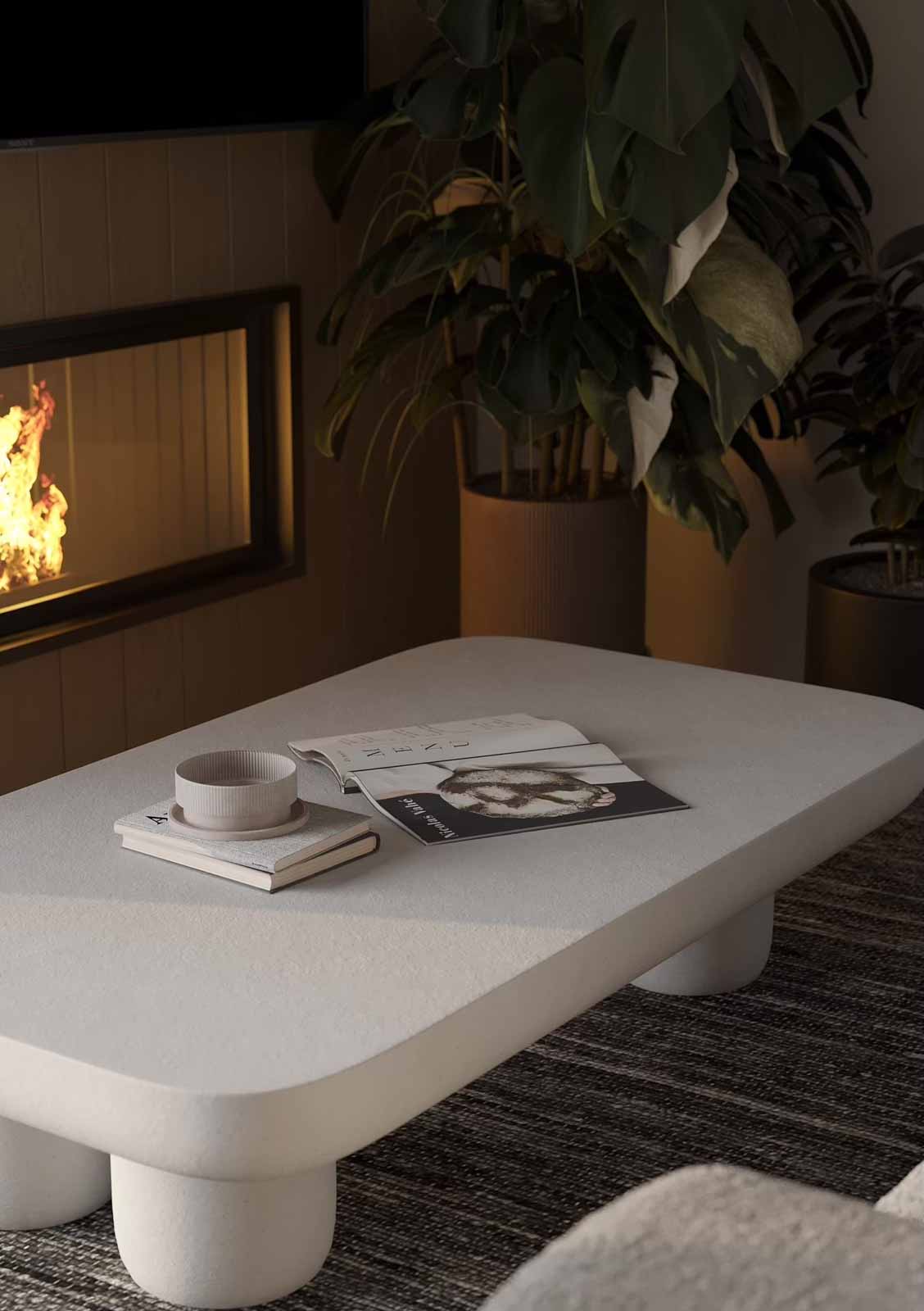 Cozy fireplace vignette with white textured coffee table, magazines, and monstera plant