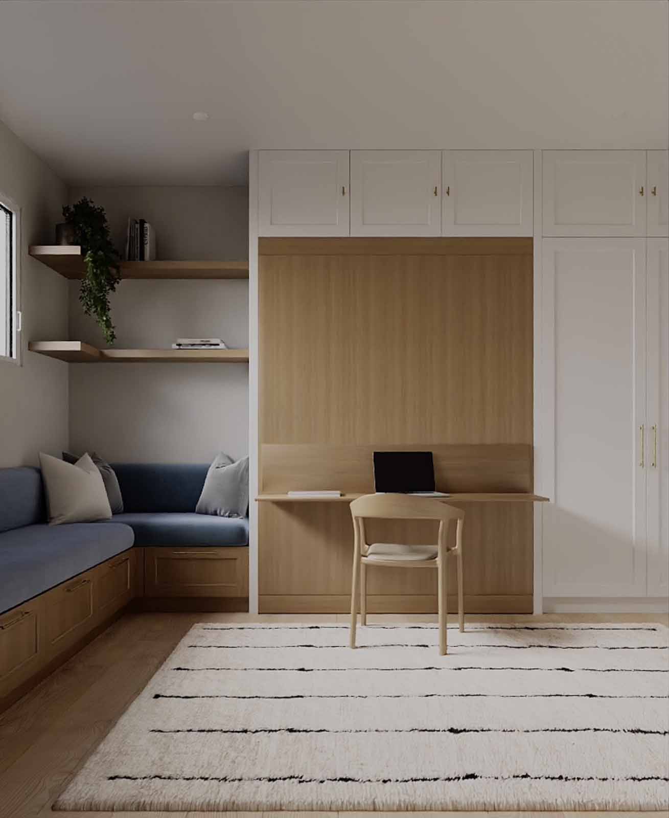Multi-function room with blue banquette, built-in desk nook, and white cabinetry