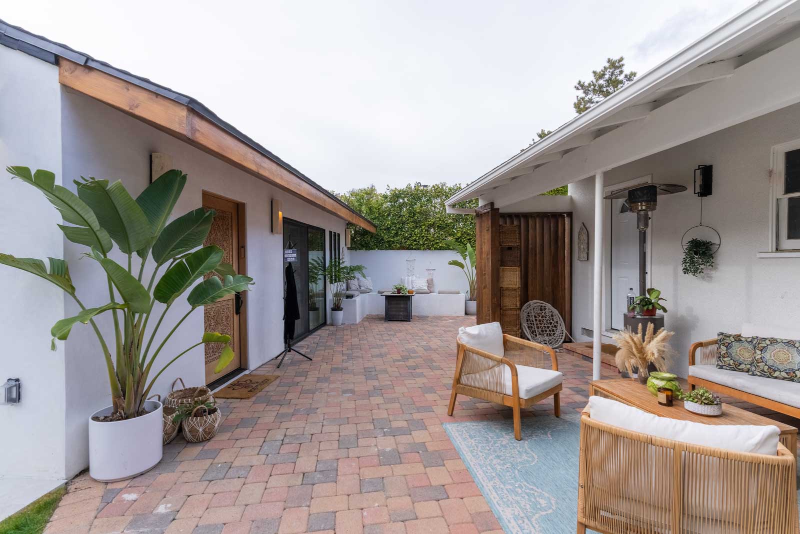 Pasadena ADU patio area with pavers, bistro seating, and landscaping providing private outdoor living space