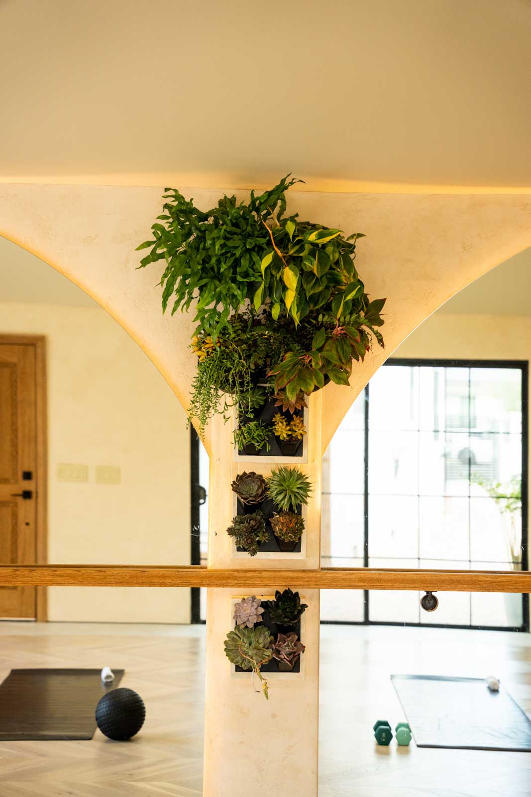 Los Angeles ADU interior featuring vertical plant wall, natural wood elements, and biophilic design bringing nature indoors