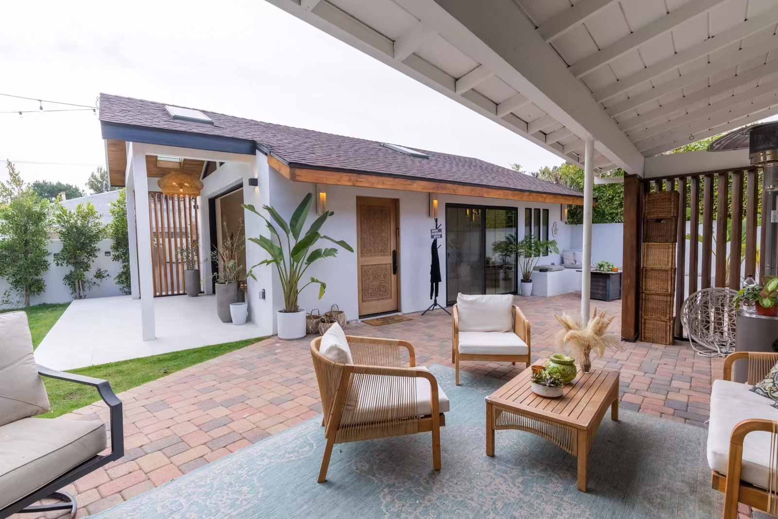 Sherman Oaks ADU with patio furniture, brick pavers, and covered seating area