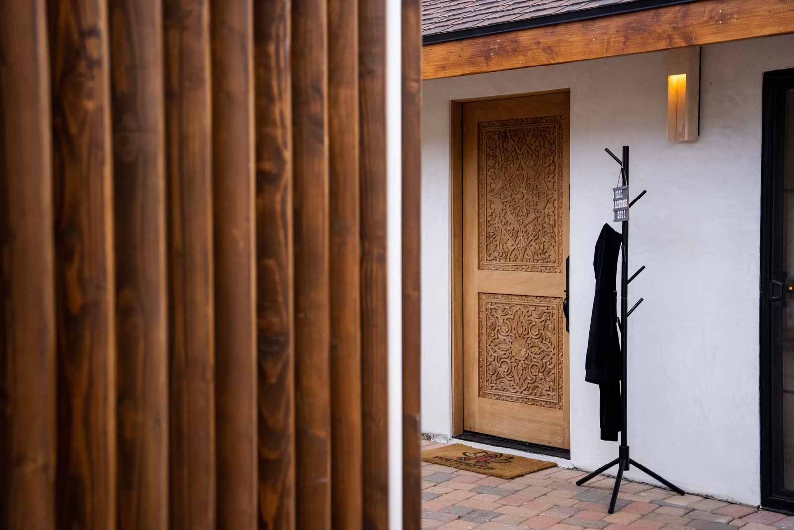 Beautiful hand-carved Balinese wood entry door with coat rack