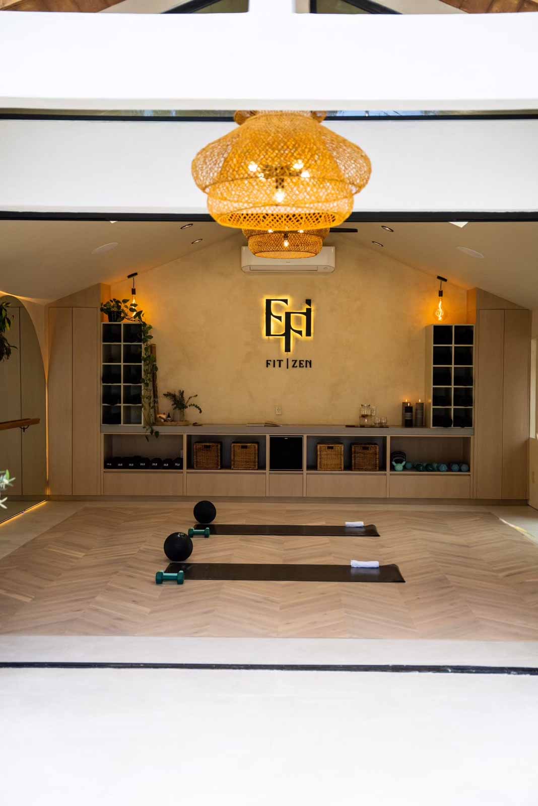 Looking through entrance at rattan chandelier and studio interior