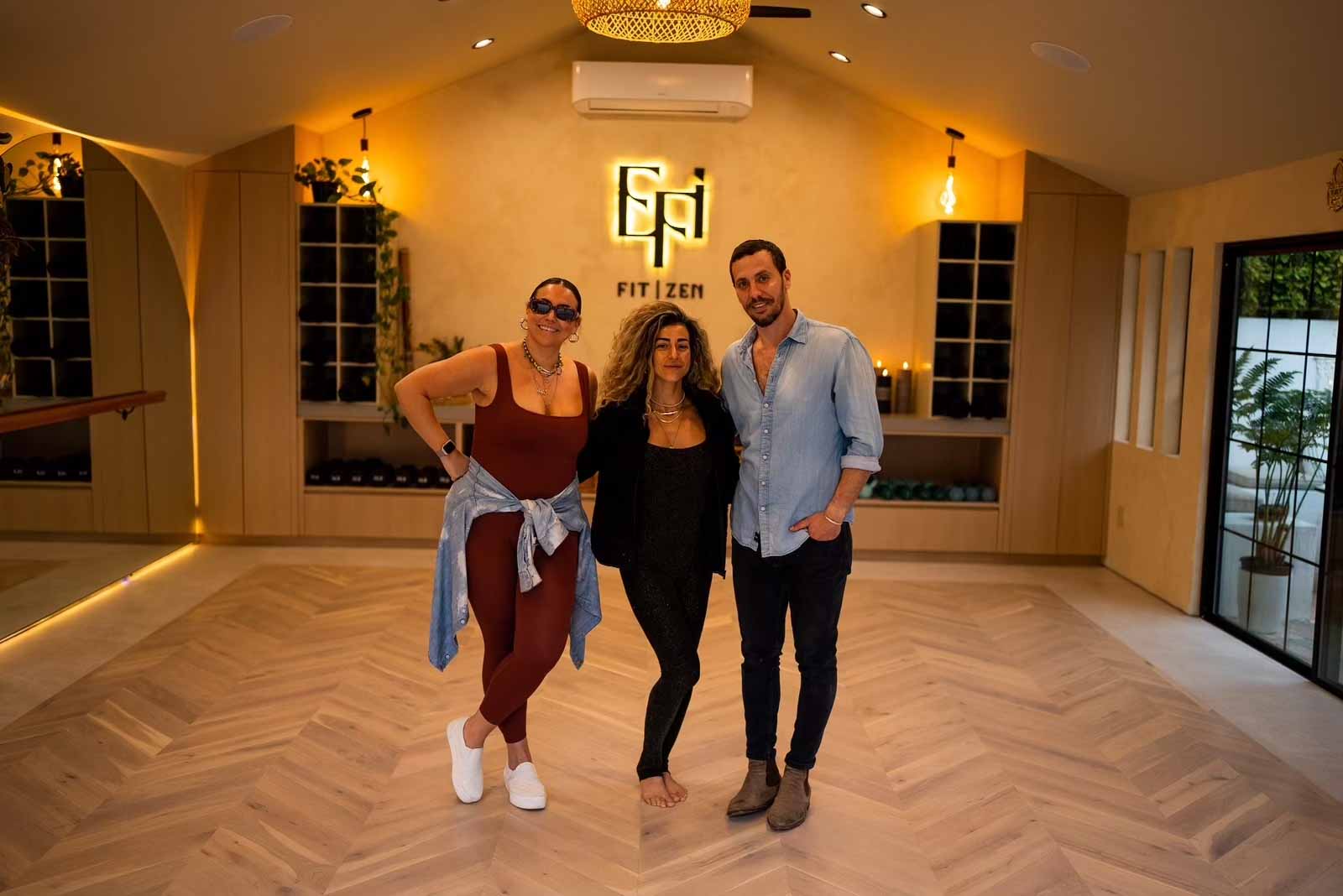 New Dawn Construction team with client in completed yoga studio