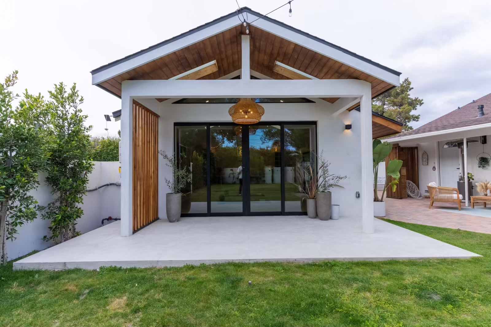 Sherman Oaks ADU exterior with wood slat accent, vaulted roof, and sliding glass doors
