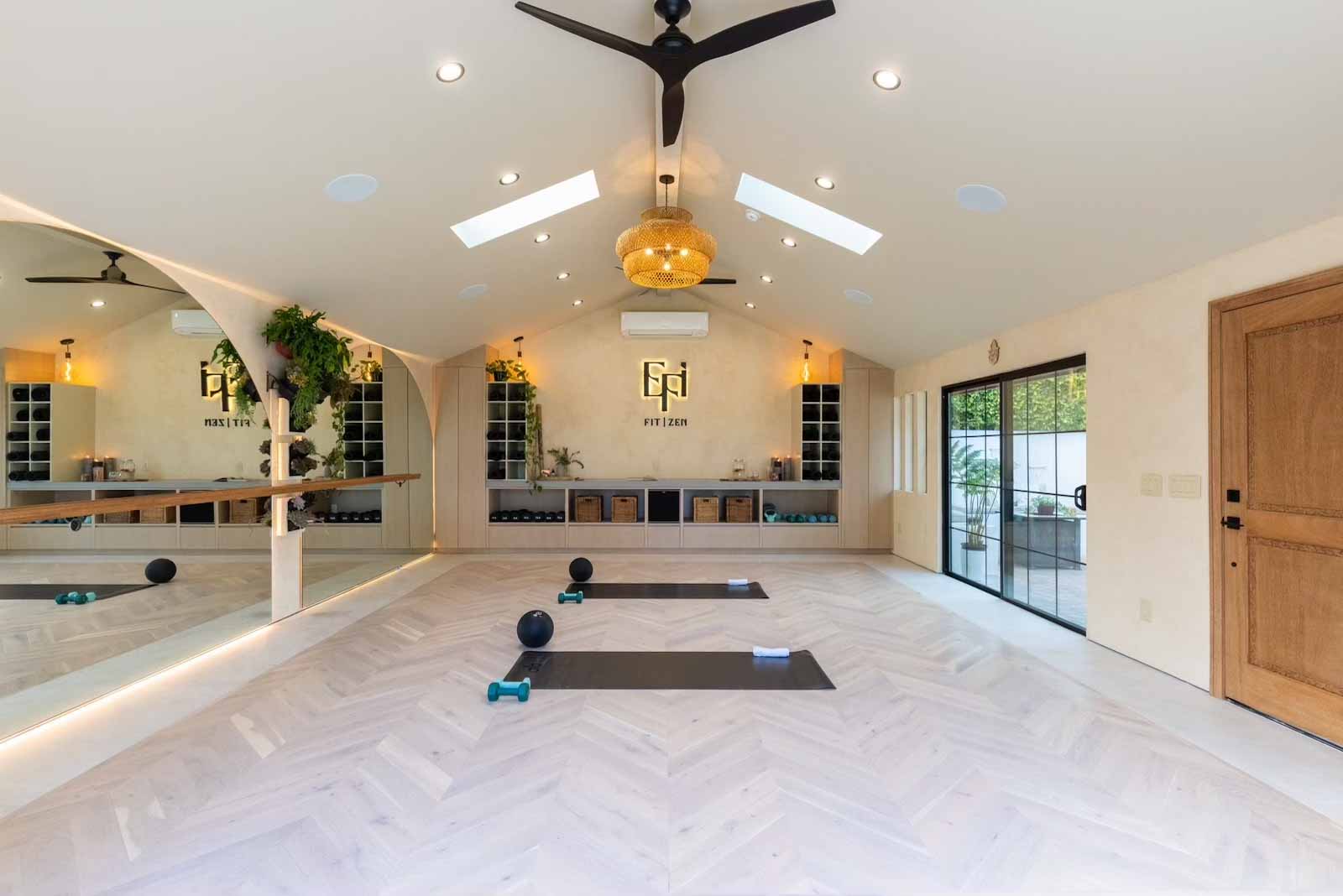 Yoga studio interior showing full mirror wall, barre, and natural light