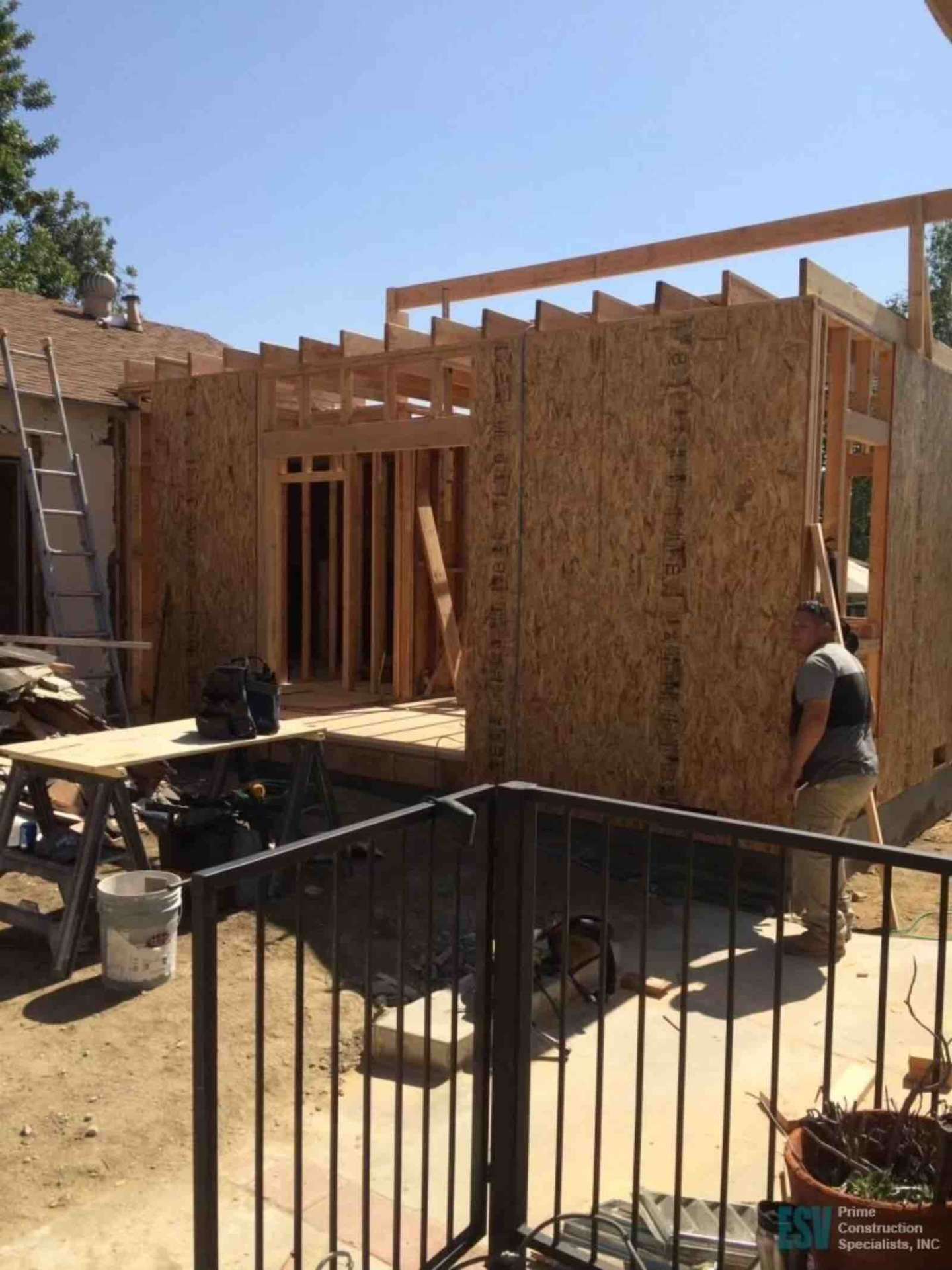 Los Angeles room addition construction with OSB wall sheathing and roof framing in progress