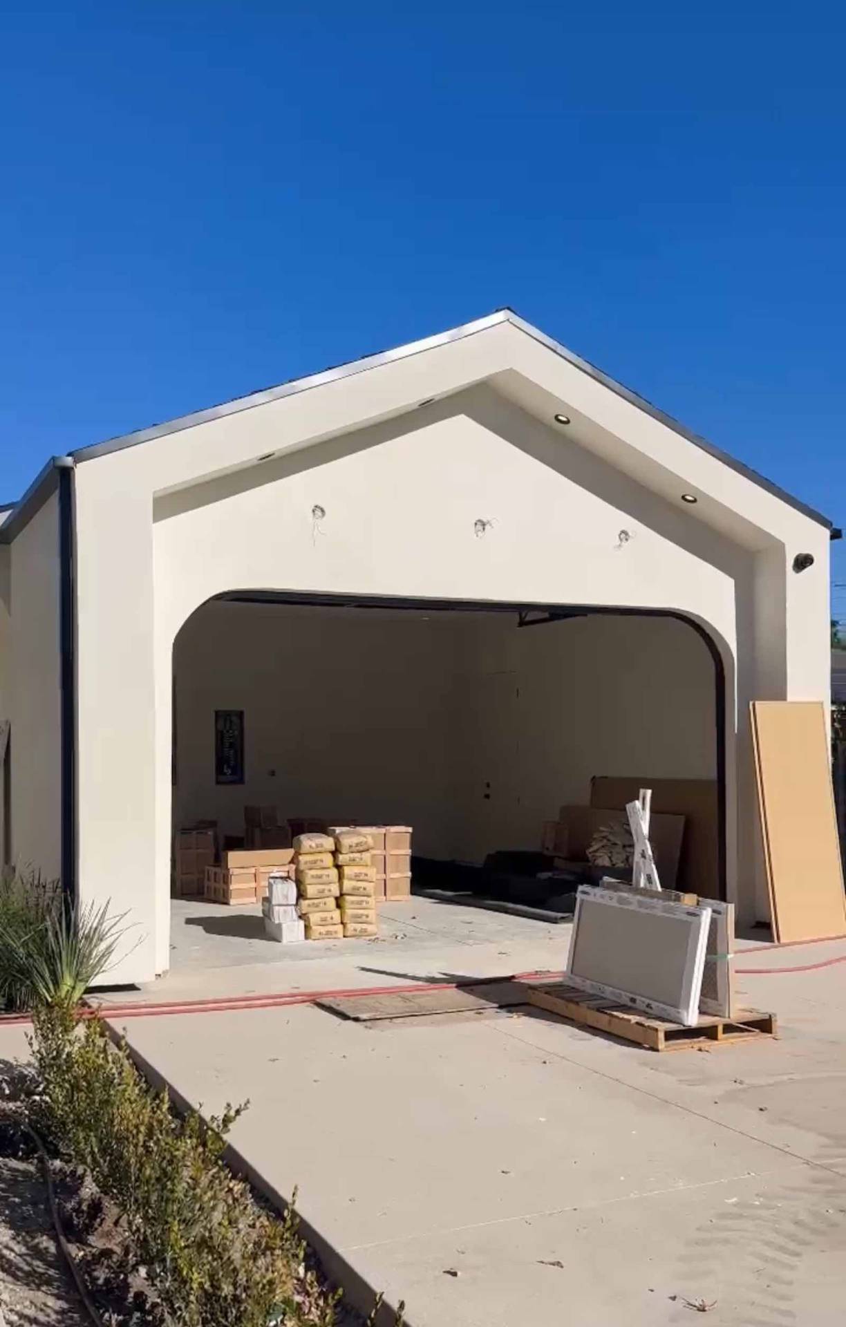 Encino ADU garage under construction with white stucco exterior and arched opening