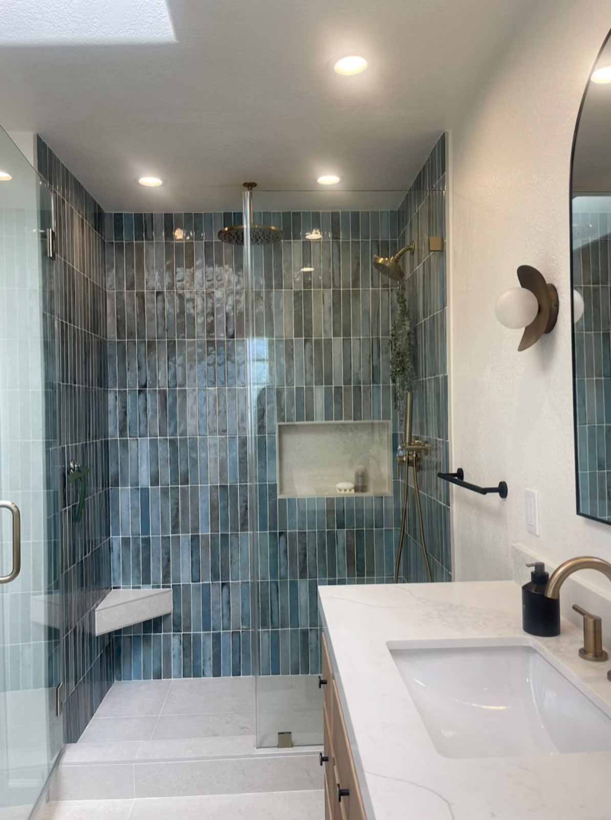 Glendale bathroom wide view showing blue tile shower and modern single sink vanity