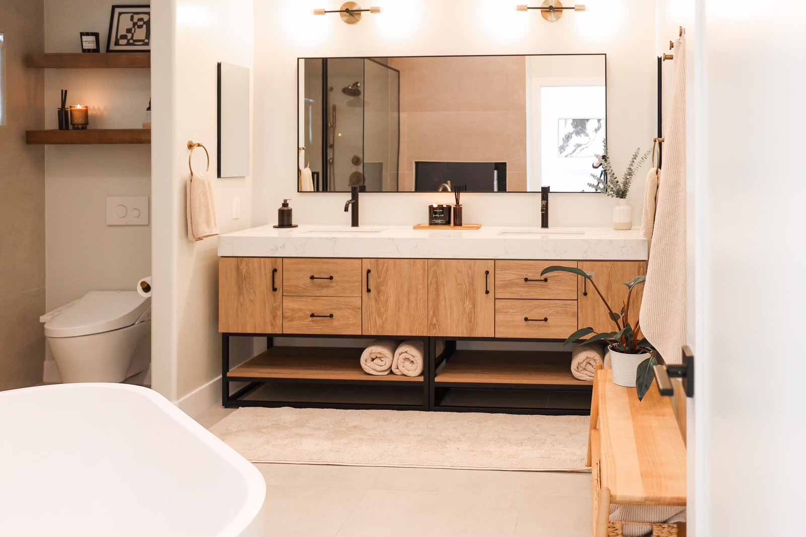 Long Beach double vanity bathroom with oak cabinets, dual sinks, and large mirror