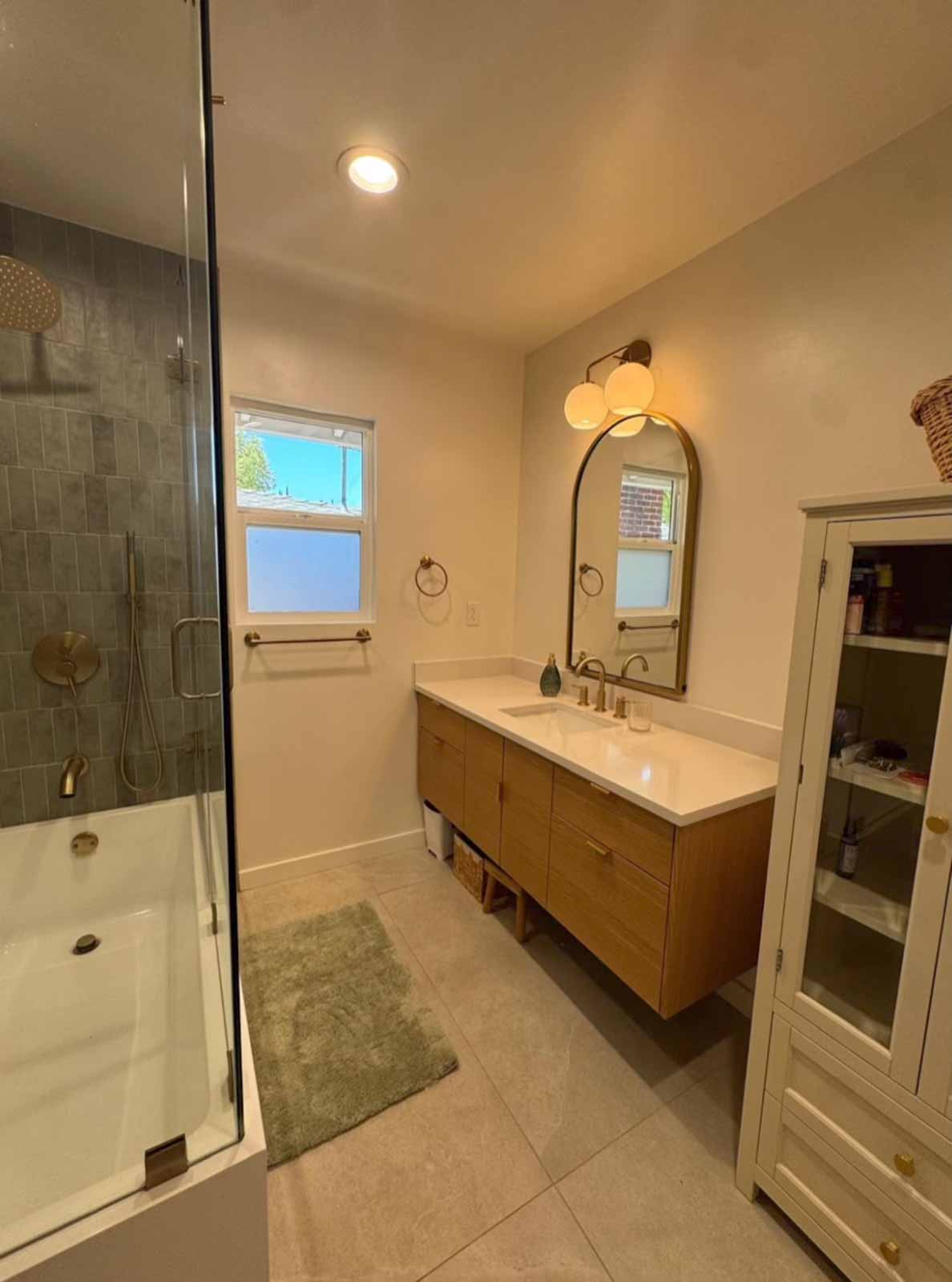 Full Pasadena bathroom view with tub-shower combo, oak vanity, and natural light