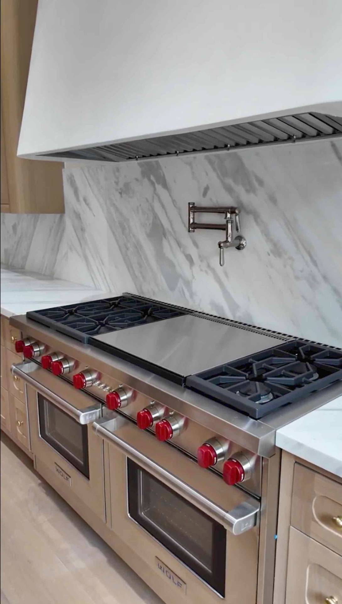 Brentwood kitchen Wolf range with marble backsplash and pot filler