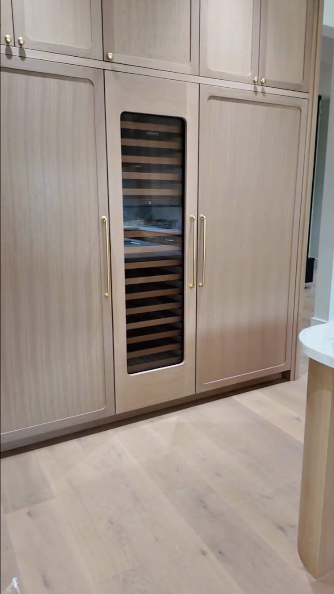 Brentwood kitchen built-in wine refrigerator with oak paneling
