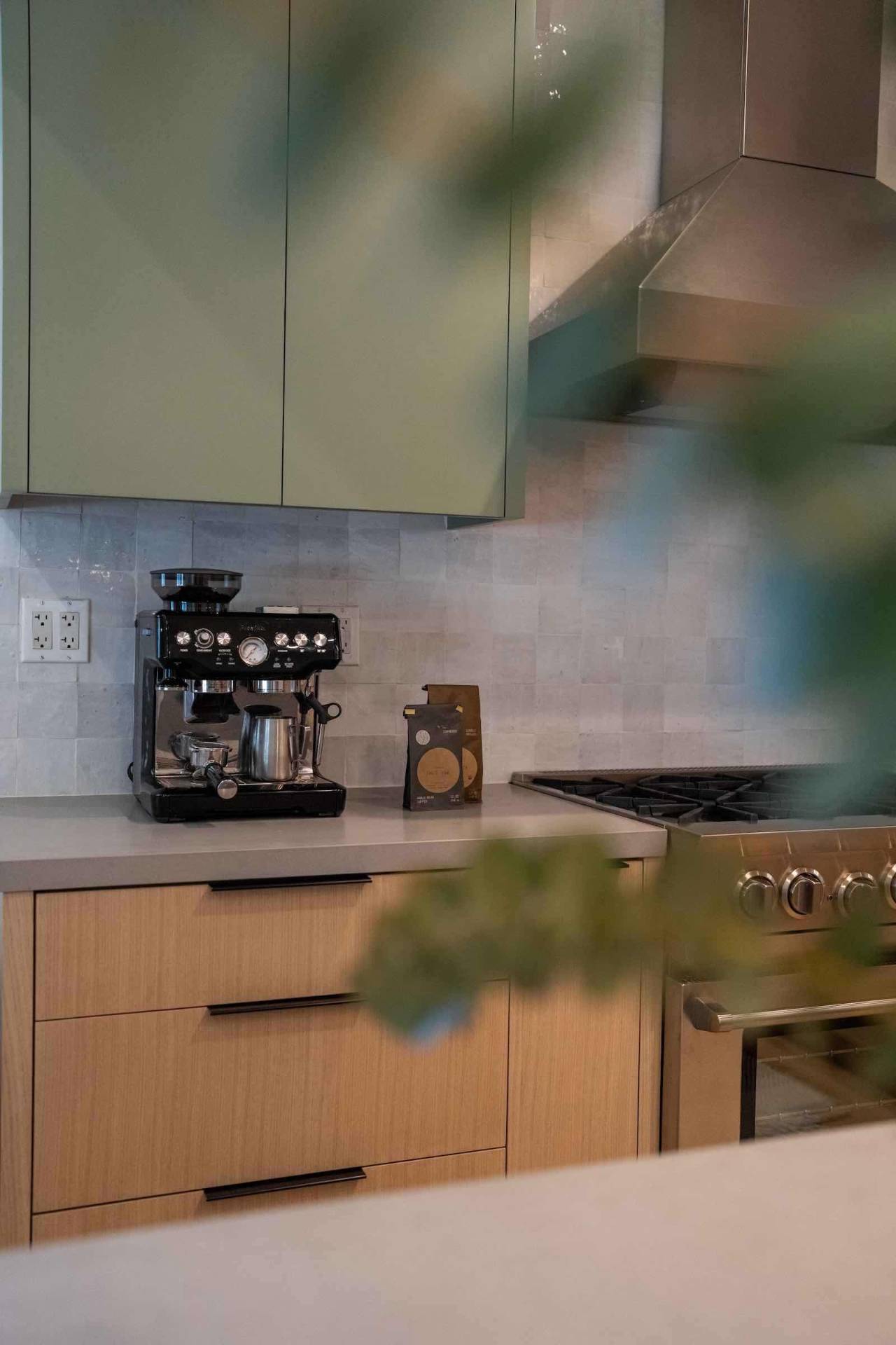 Claremont kitchen coffee station with sage cabinets and espresso machine