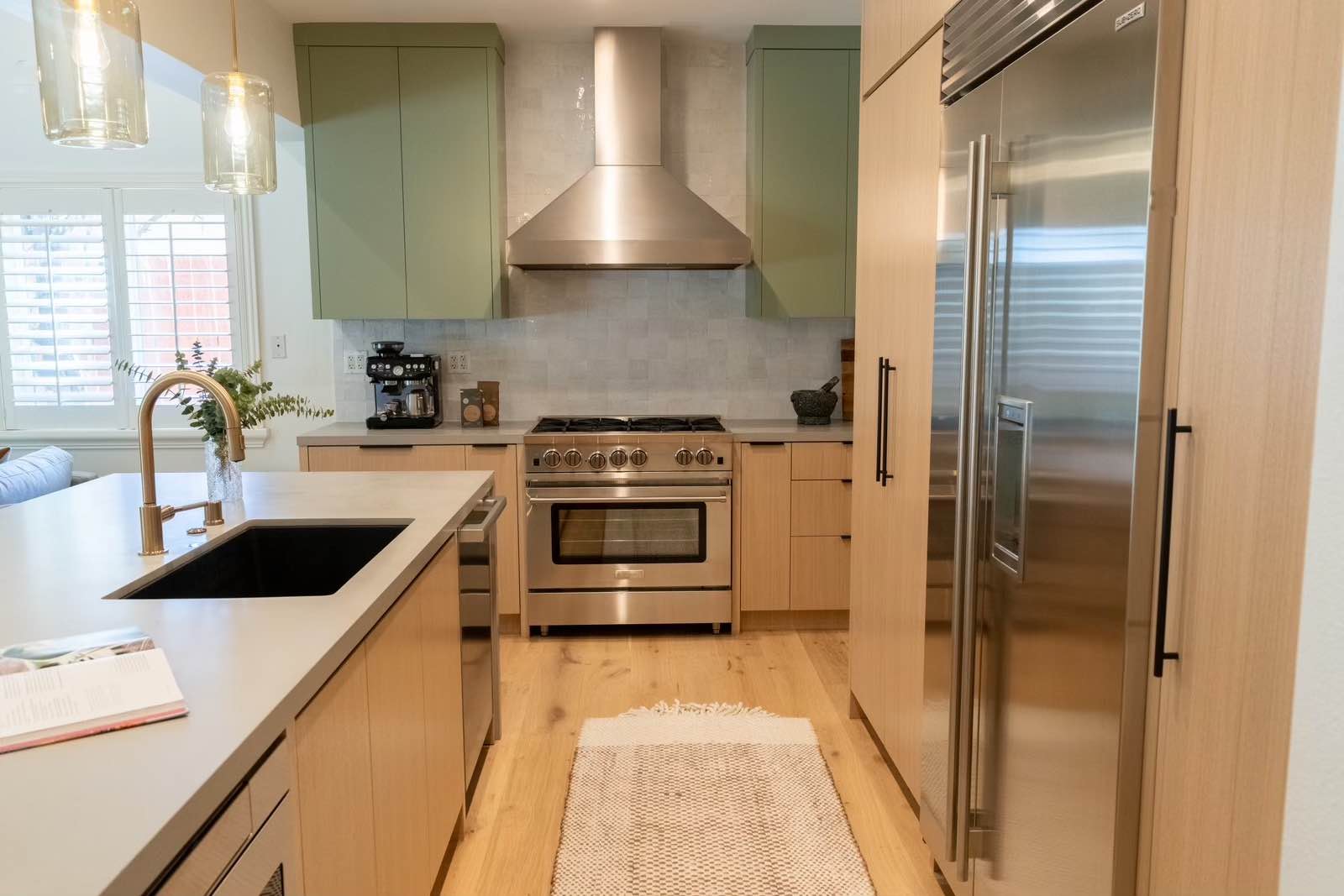 Claremont kitchen full view with white oak and sage green two-tone cabinets