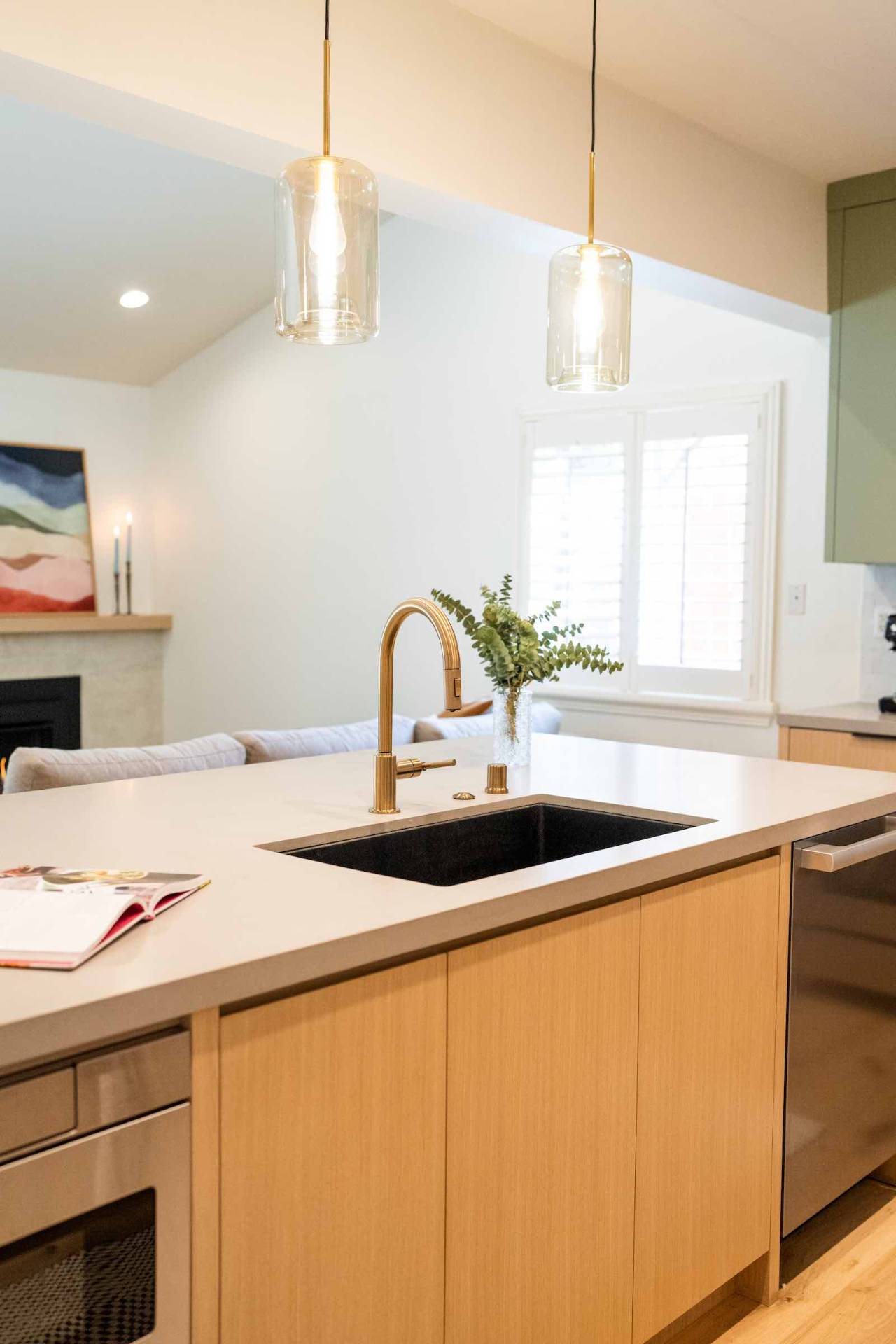 Claremont kitchen island with black sink and glass pendants