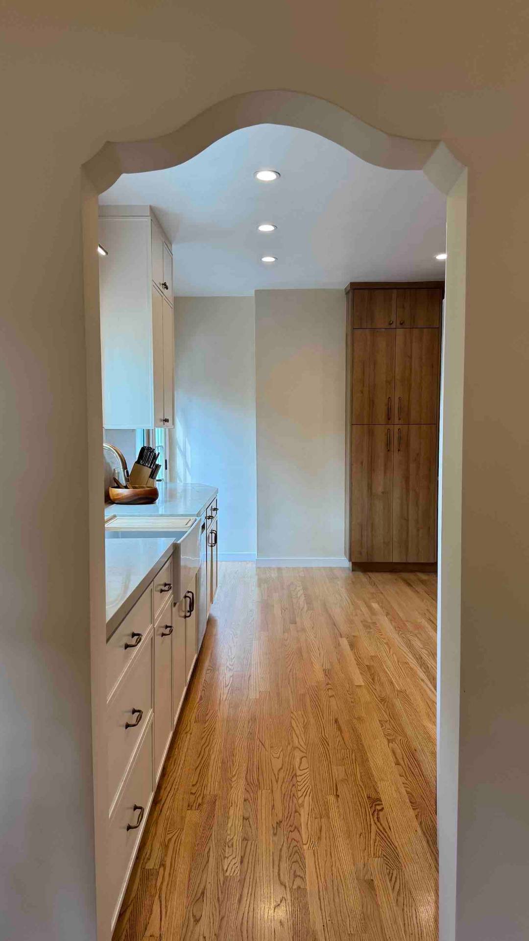 Rancho Park kitchen decorative archway entry with hardwood floors