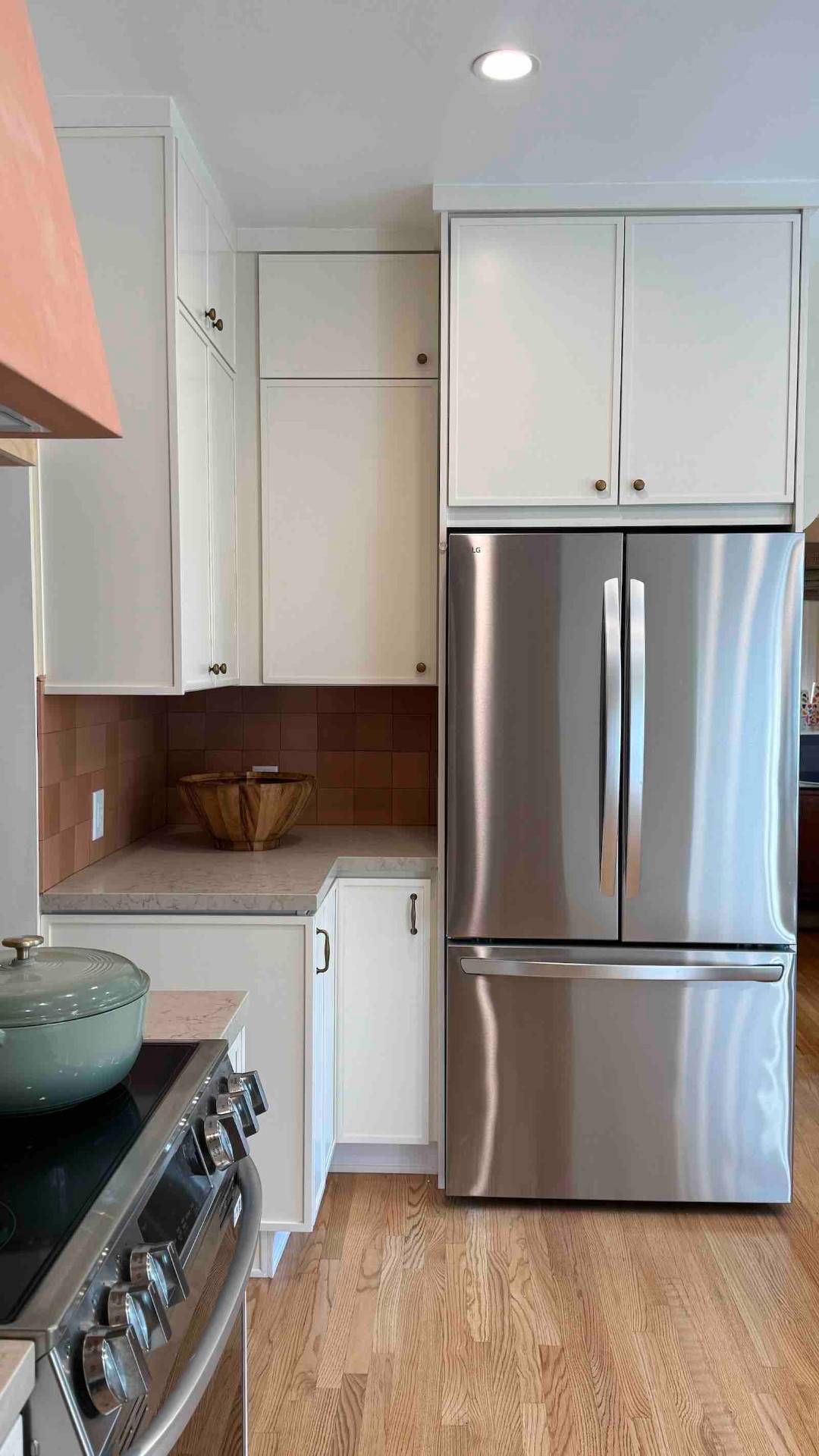 Rancho Park kitchen white cabinets with terracotta tile and LG refrigerator