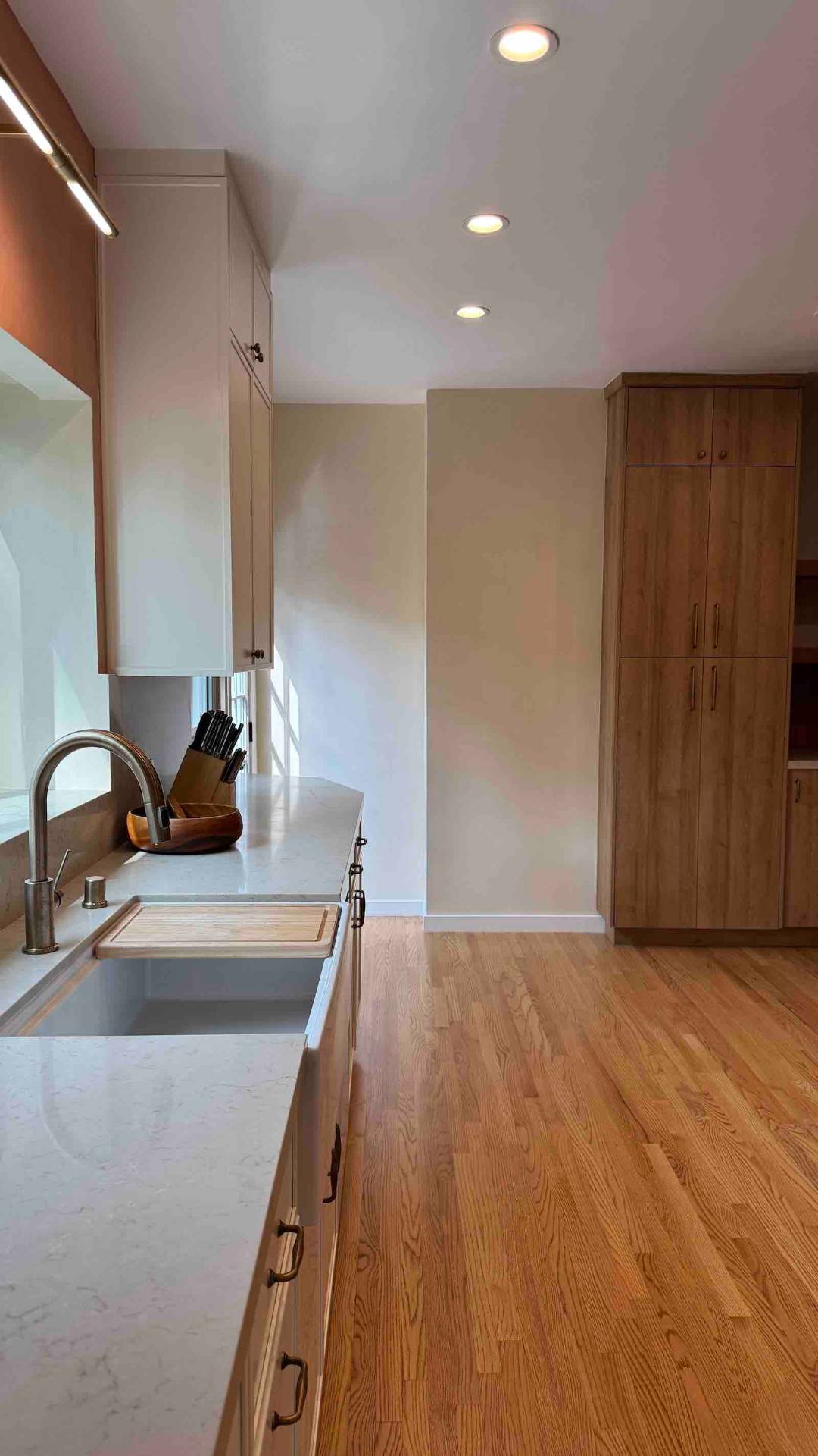 Rancho Park kitchen galley view with sink and oak storage