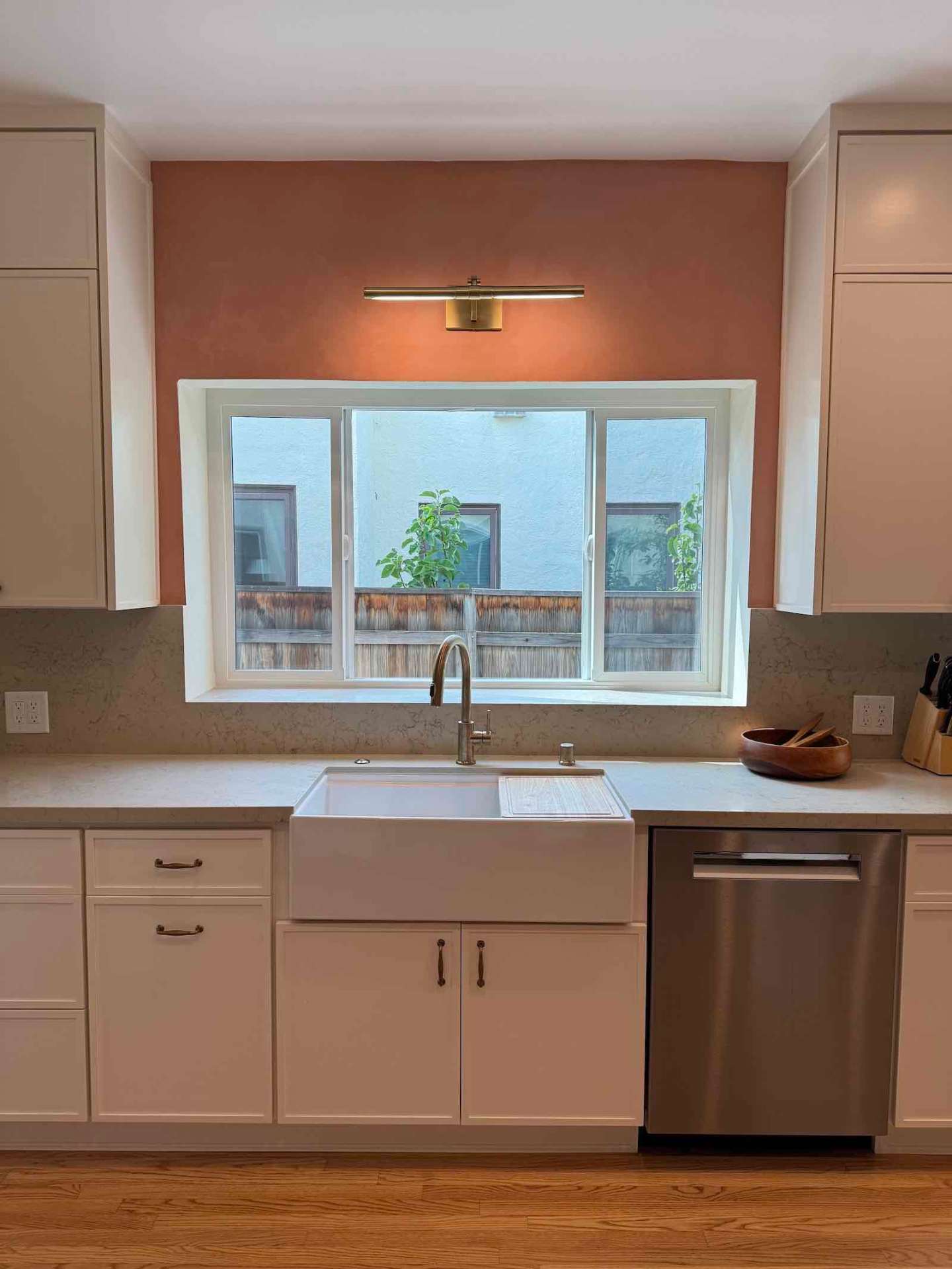 Rancho Park kitchen farmhouse sink with brass light fixture and terracotta accent wall