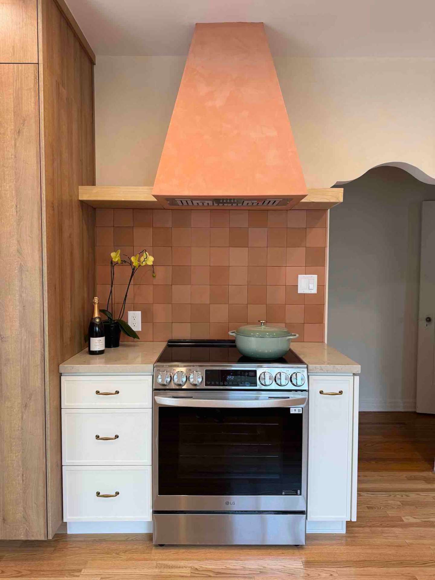 Rancho Park kitchen LG range with terracotta hood and tile backsplash