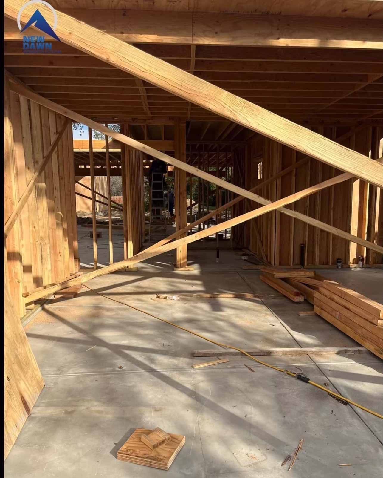 Large room addition framing Los Angeles with diagonal bracing and floor joists - New Dawn Construction in progress