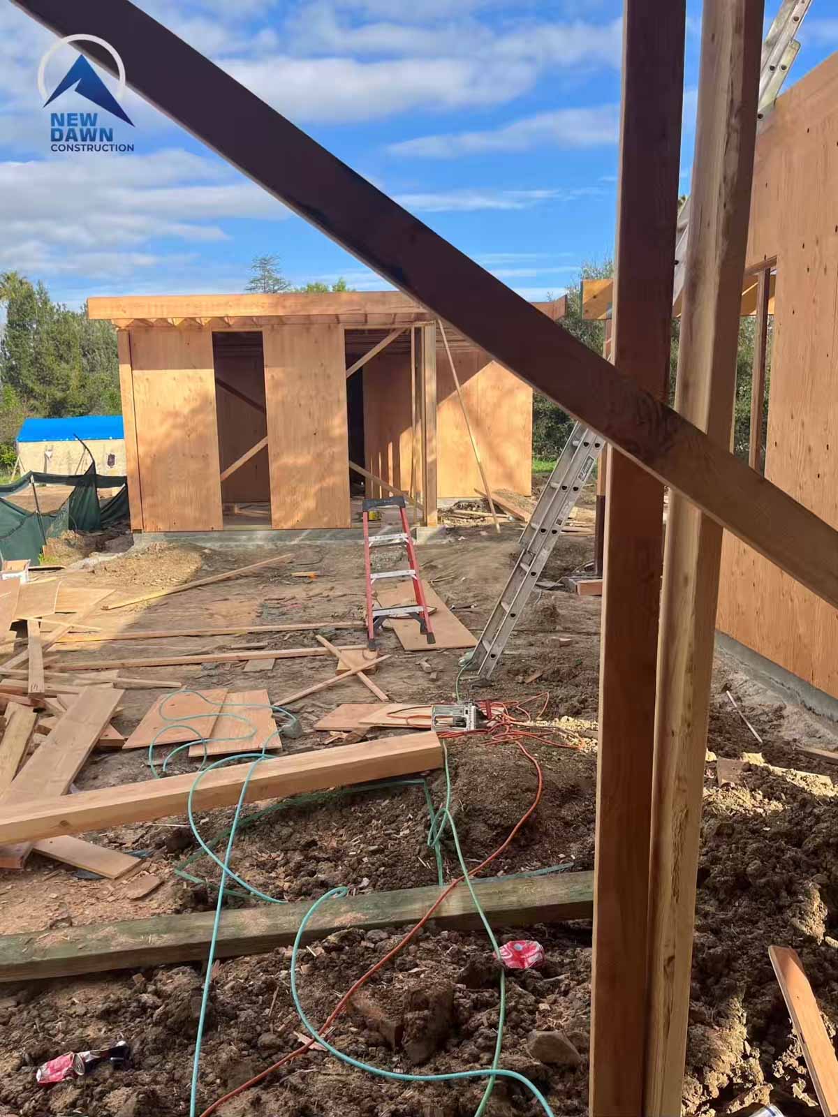 Room addition construction site with steel I-beams and wood framing - professional home expansion LA